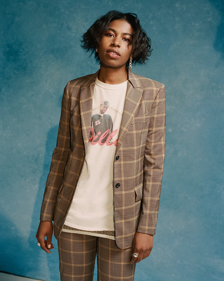 ORION wears PAUL SMITH suit and vintage t-shirt and vest from ARARA ARCHIVE, jewelry MARTINE ALI
